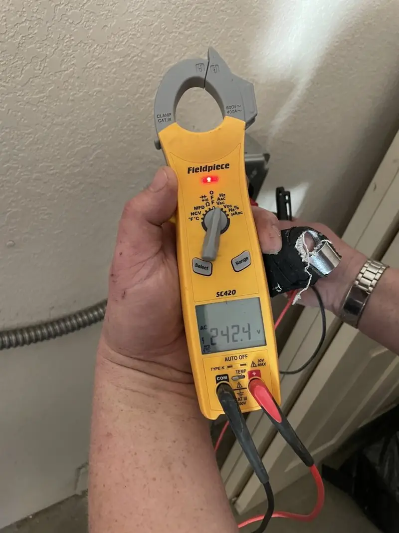 Voltage testing with clamp meter during Whole House Surge Protector in Great Neck Estates